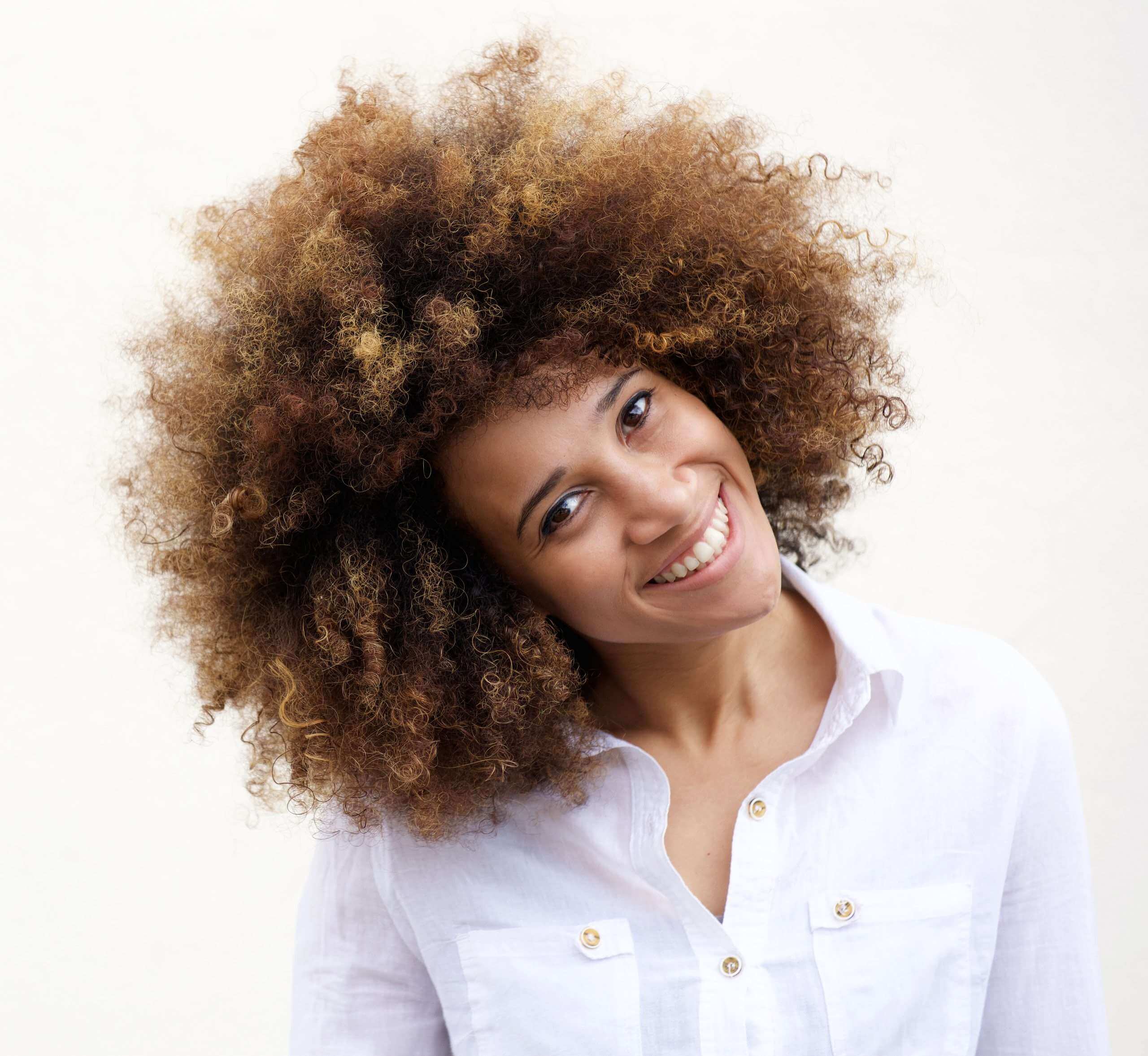 Black Girl with natural hair afro smiling, head to the side