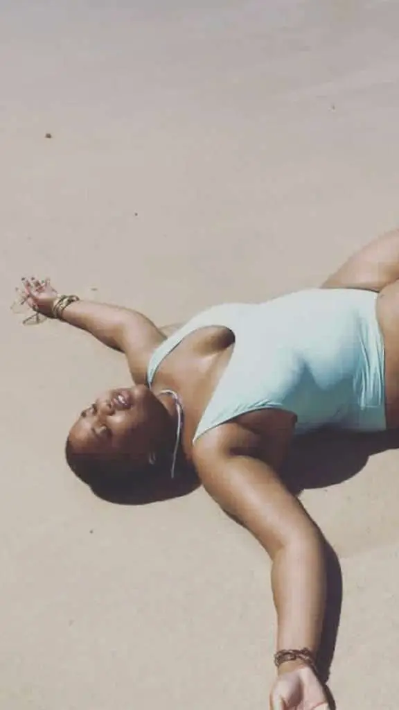 Black women laying on the beach relaxing