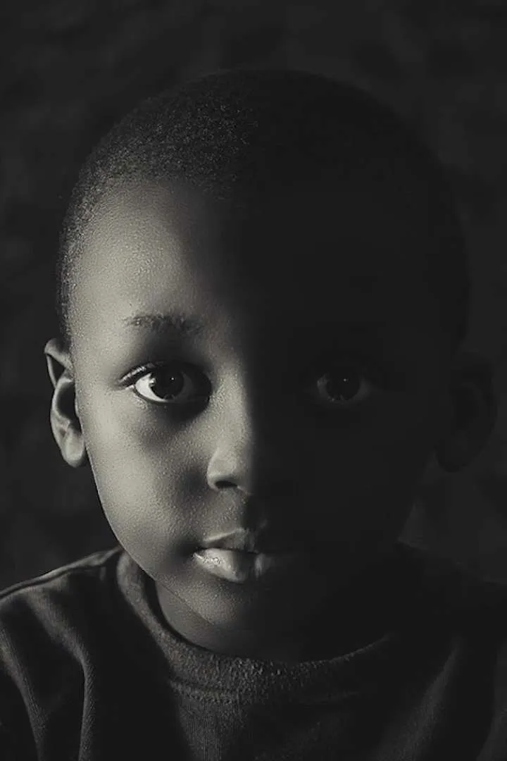 Black Child in black and white , tense photo