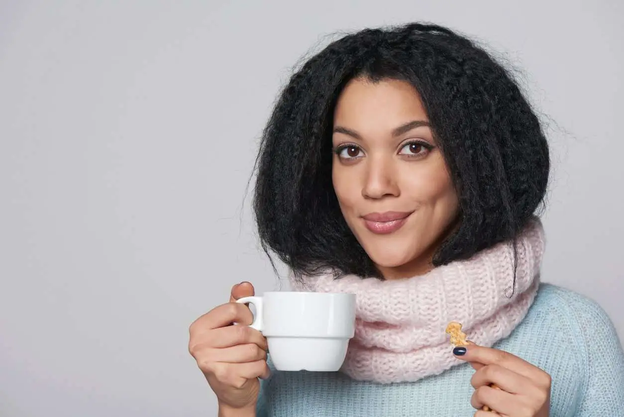 black girl drinking coffee and smiling, flirting