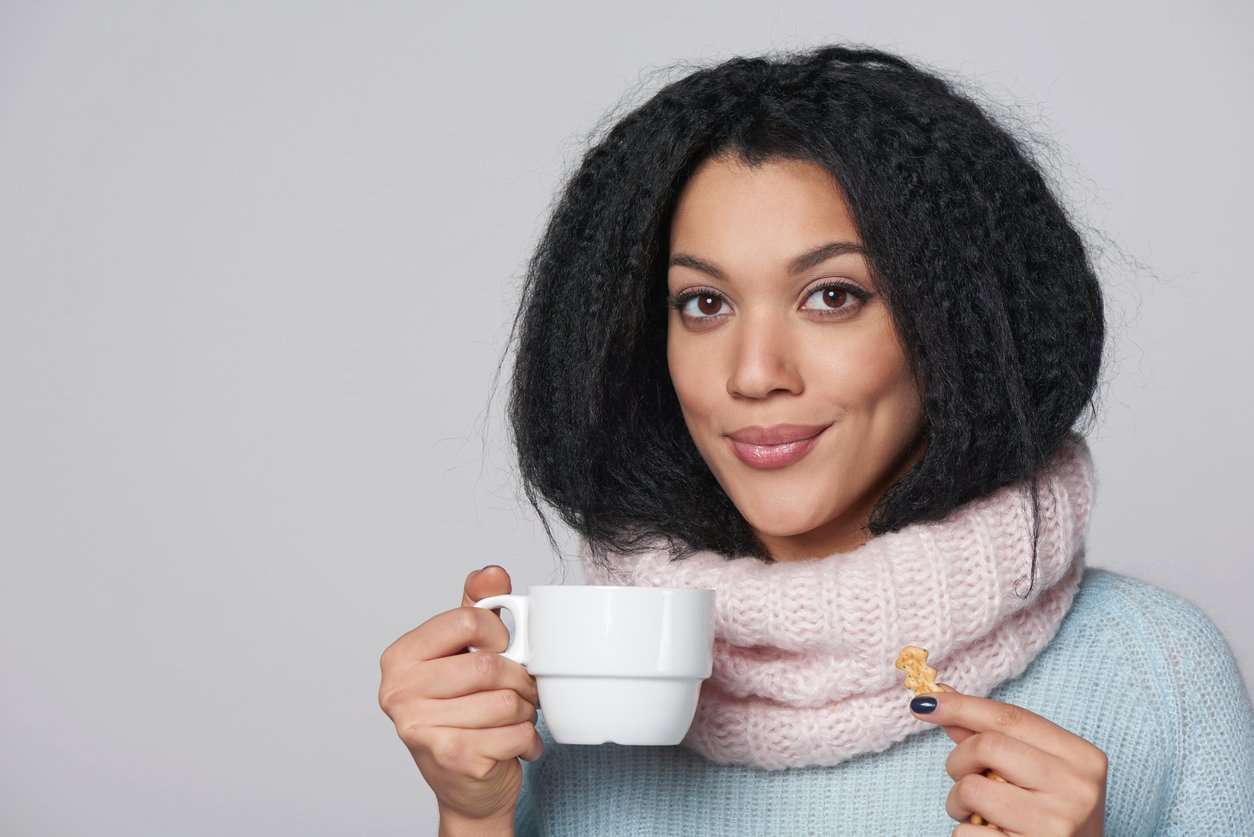 black girl drinking coffee and smiling, flirting