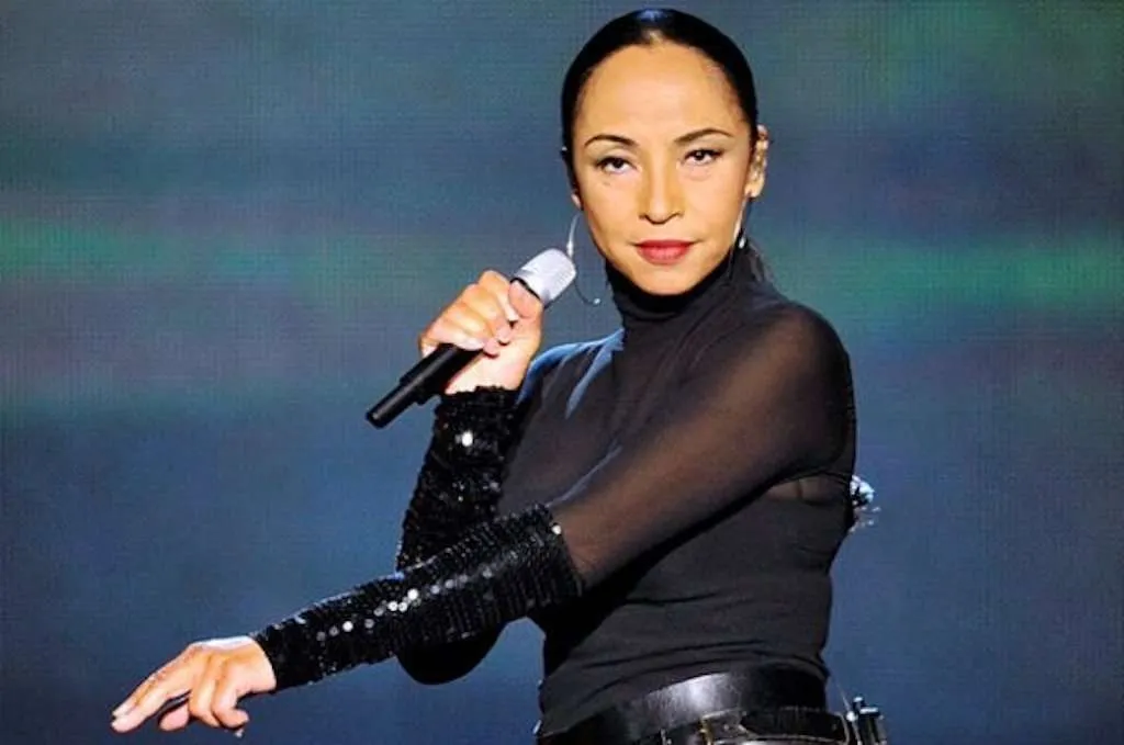 Sade making a come back wearing all black on stage performing