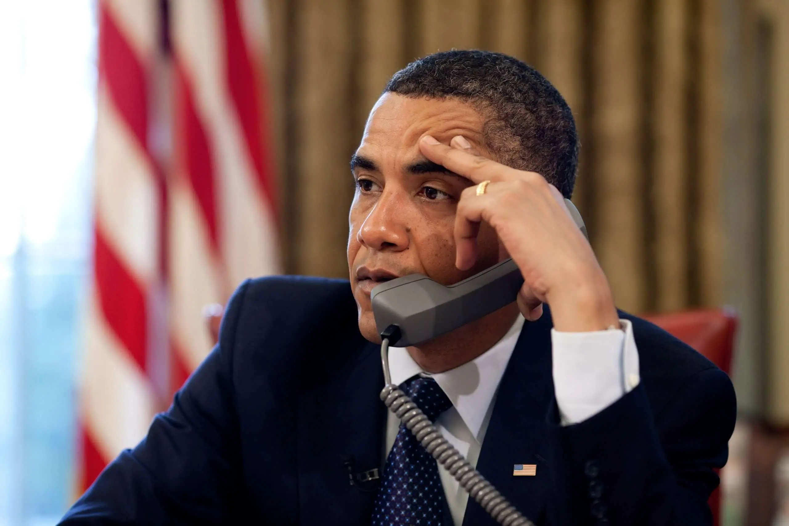 Barack Obama talking on the phone in the White House