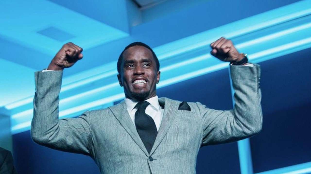 Diddy posing with his hands up showing he is one of the highest paid musicians