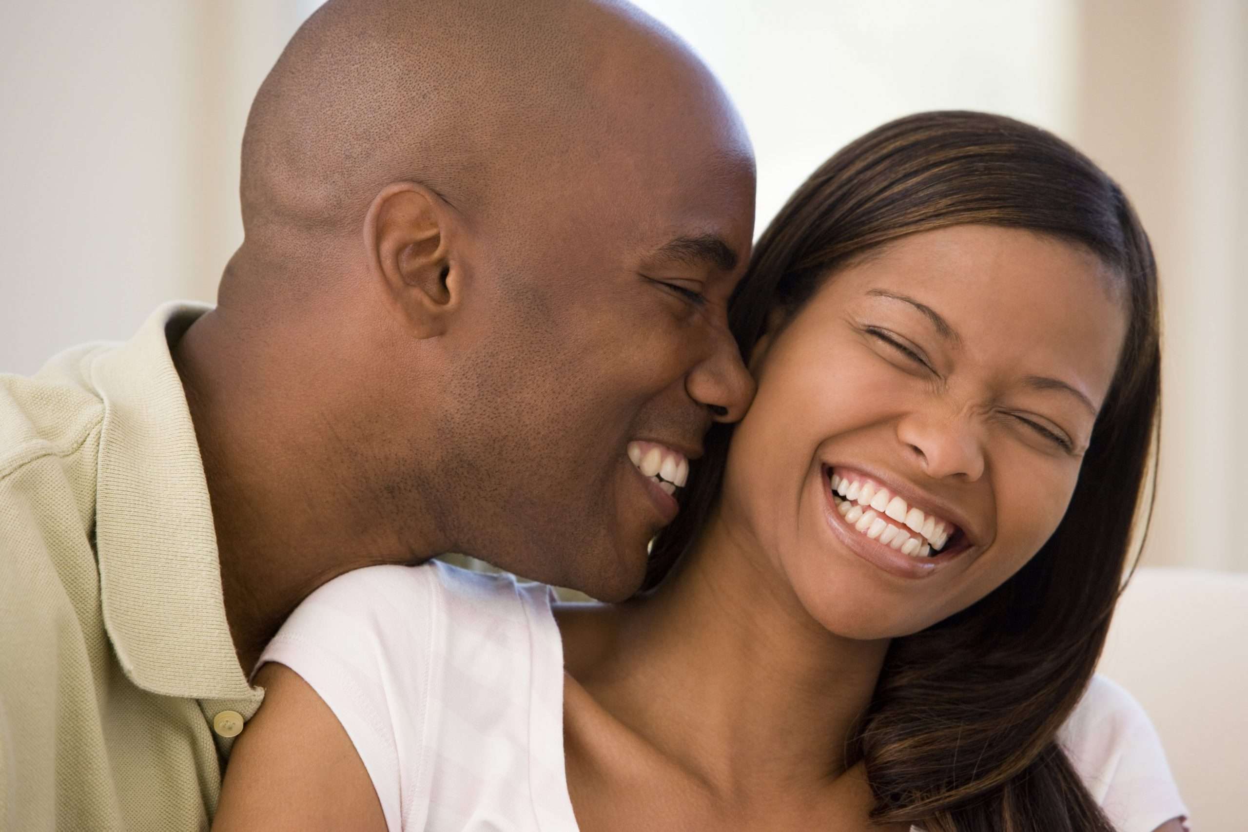 Black Couple smiling with joy hugging each other