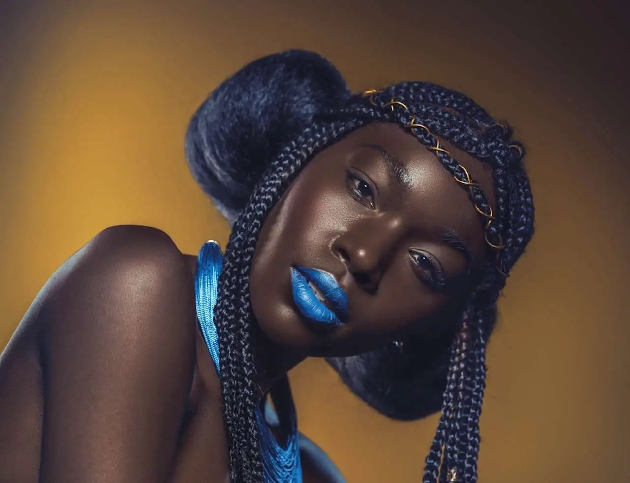 Black girl with natural hair and gold in it. With Blue Lipstick