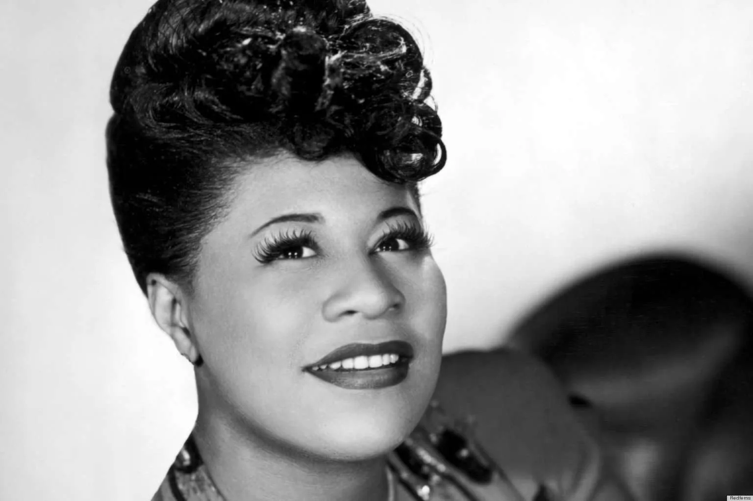 Ella Fitzgerald starring up at the lights smiling