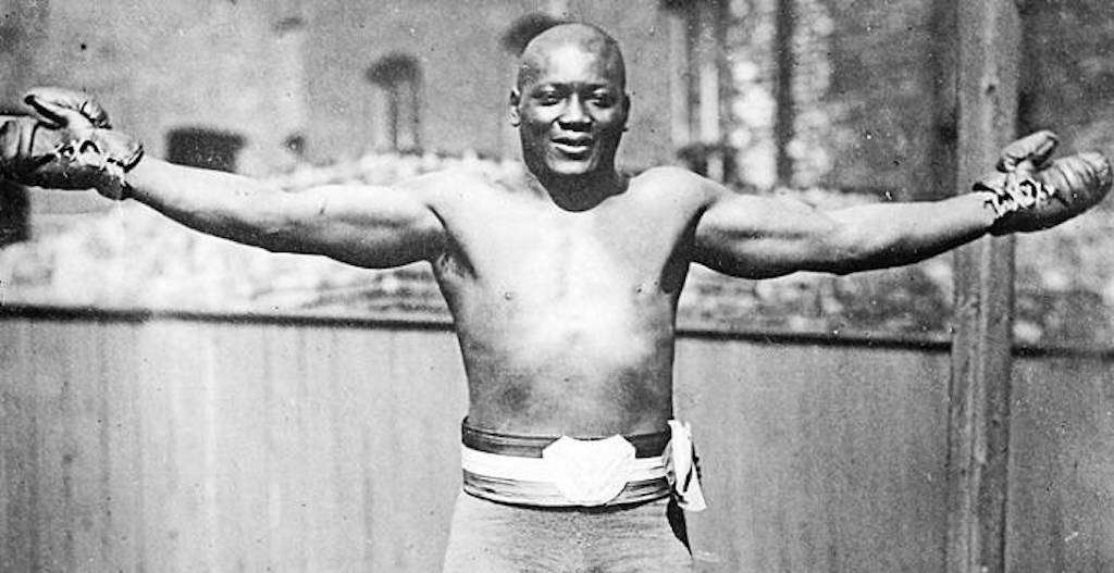 Boxer jack johnson holding up his hands after he won