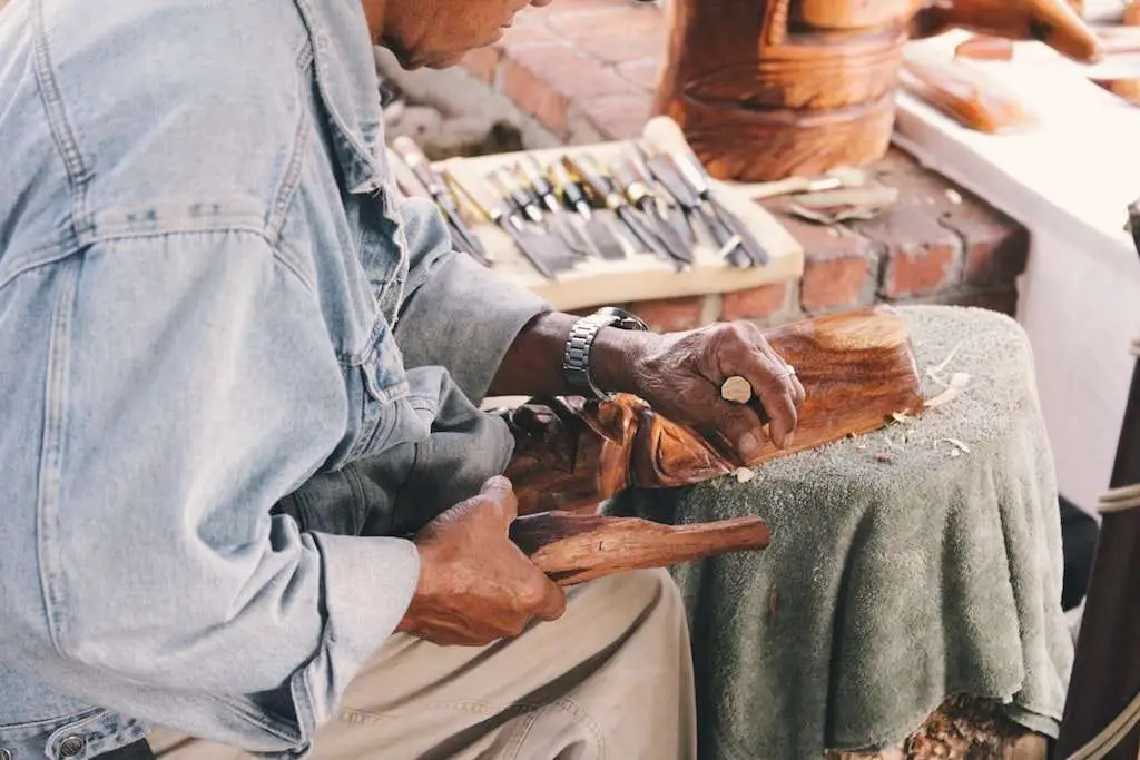 black man doing wood cutting