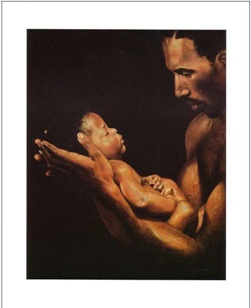 Black father holding is child painting