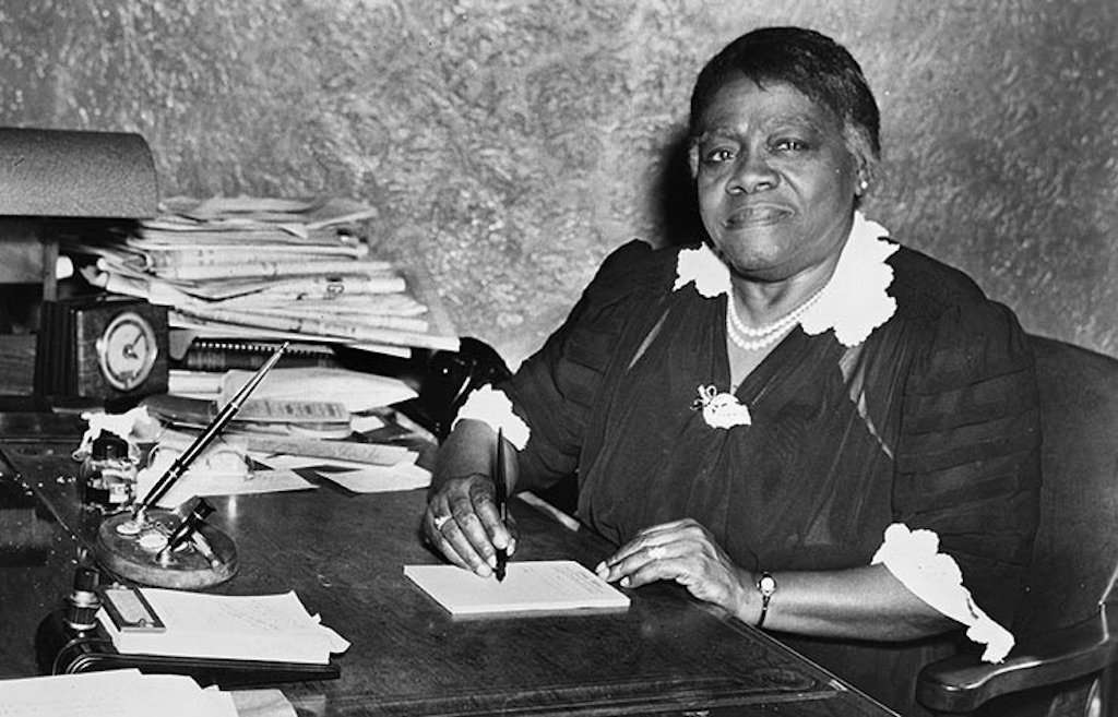 Mary McLeod Bethune writing at a desk writing
