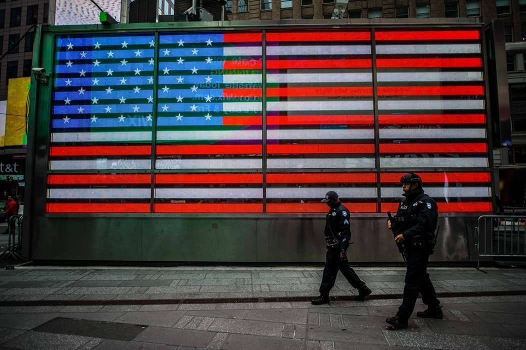 Police in front of a american flag in New York