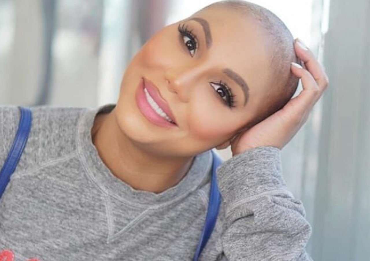 Tamar Braxton with a shaved head smiling
