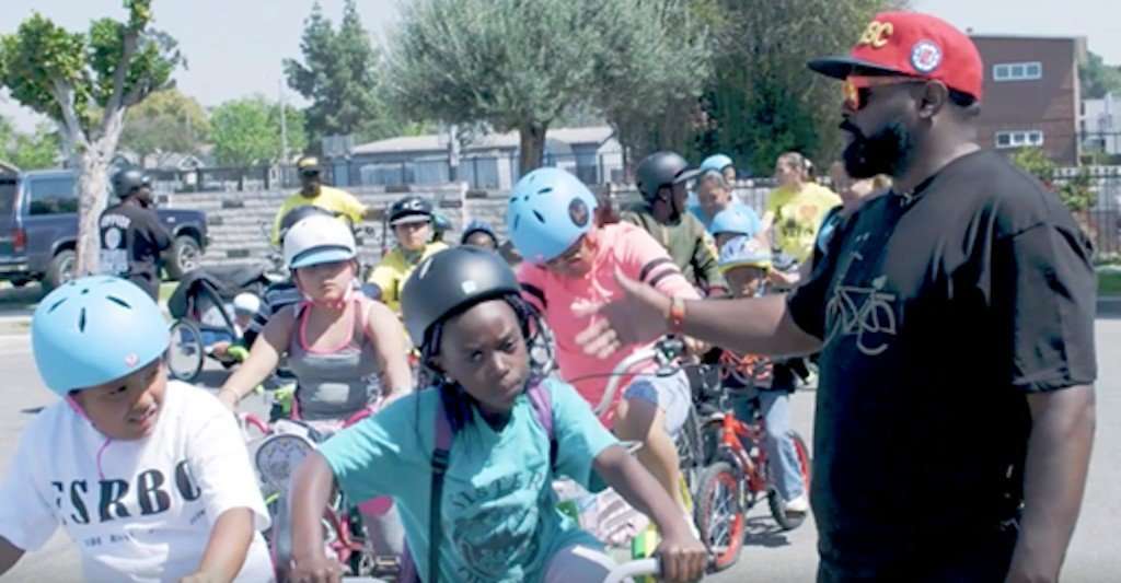 black male community leader in Los Angeles talking to children in Los Angeles