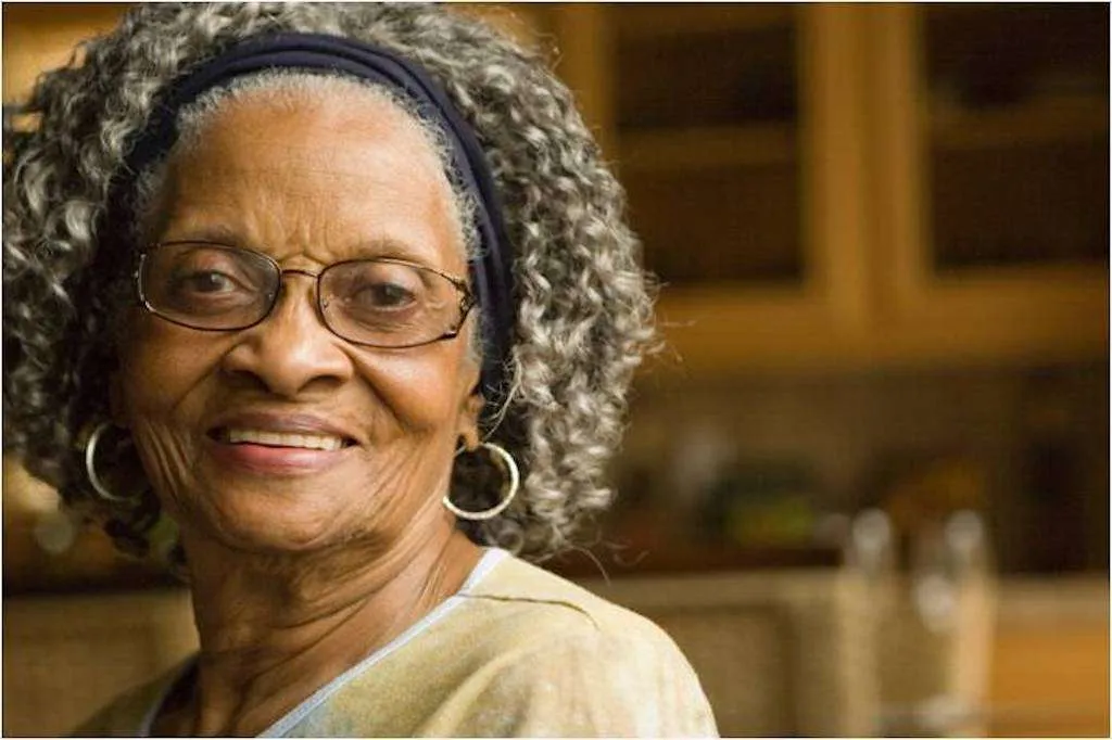 Black grandma smiling with grey hair