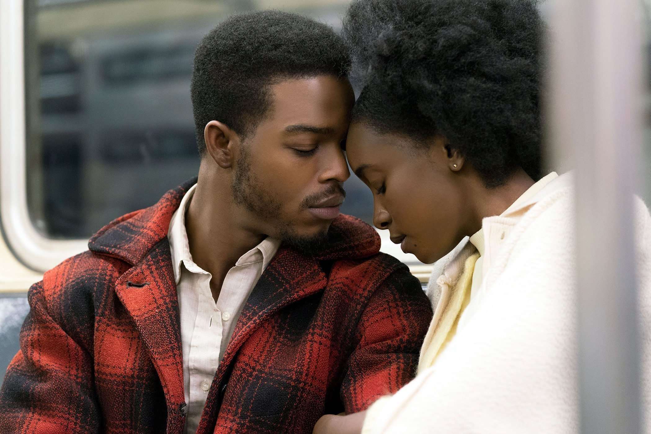 Black Couple together on a bus with heads on each other