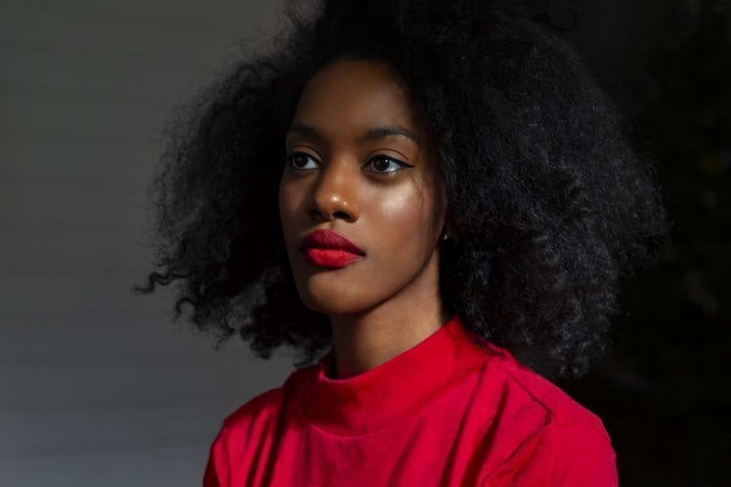 Depressed Black Women with natural hair wearing red