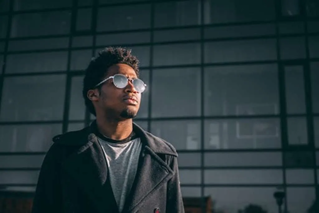 Black Entrepreneur with glasses in front of building