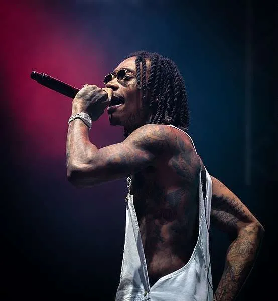 Wiz Khalifa with Dreads and a cut off shirt, Performing on stage