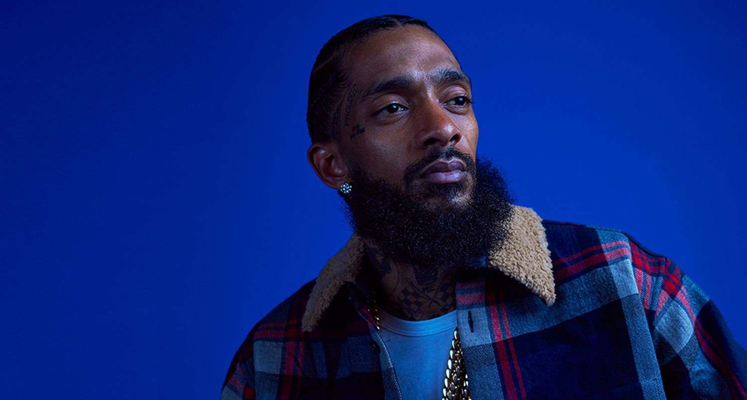 Los Angeles Rapper nipsey hussle with Blue background,