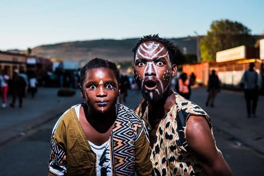 Two black children with African face paint