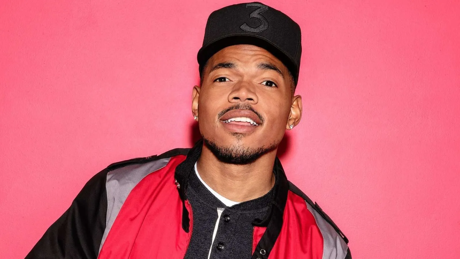 Chance the Rapper in black hat and red jacket