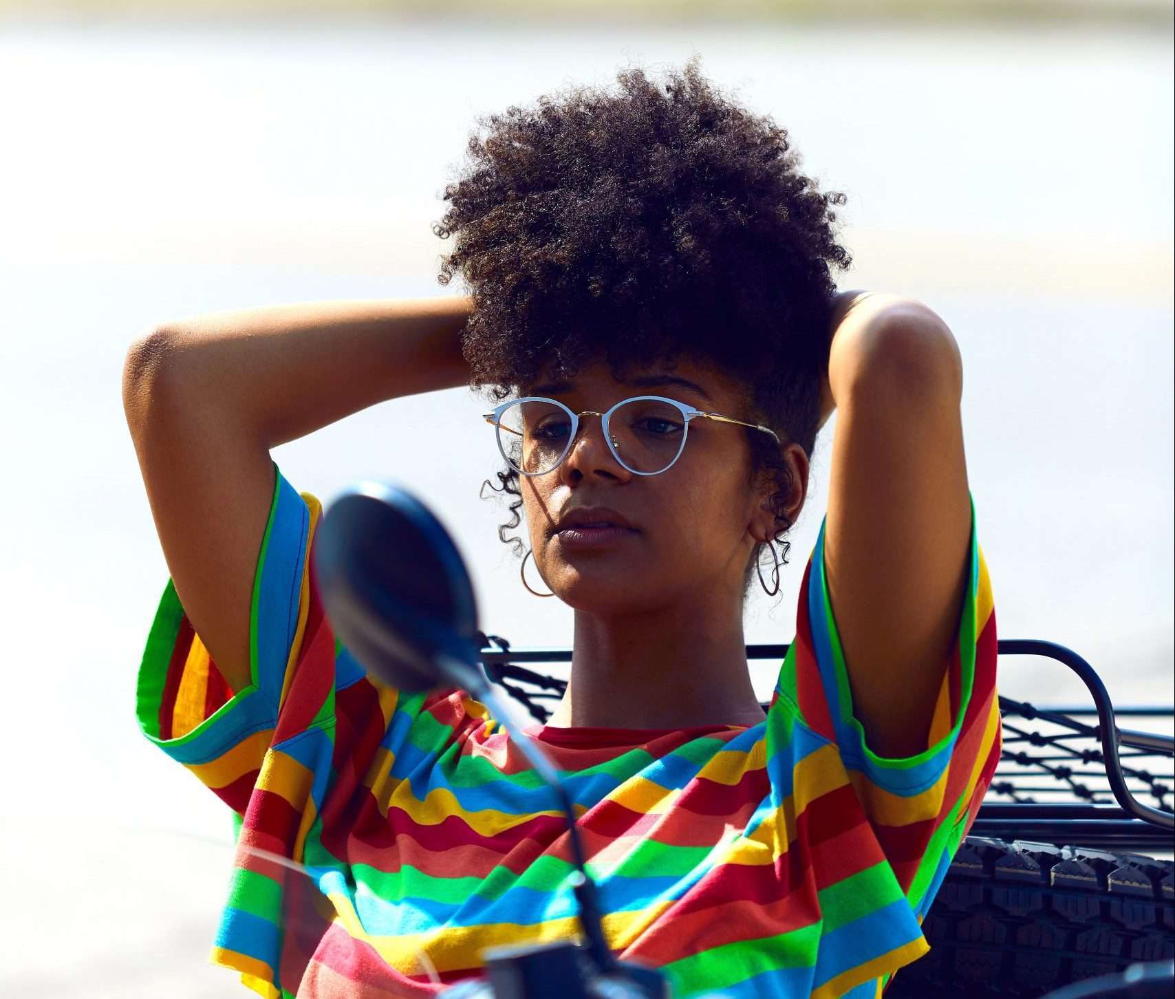 Pretty Black Girl with natural hair sitting back in a car