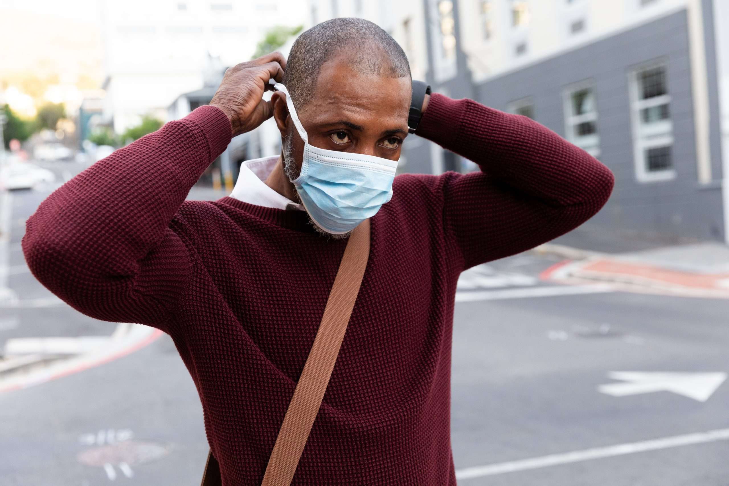 Black Man putting on a mask during covid