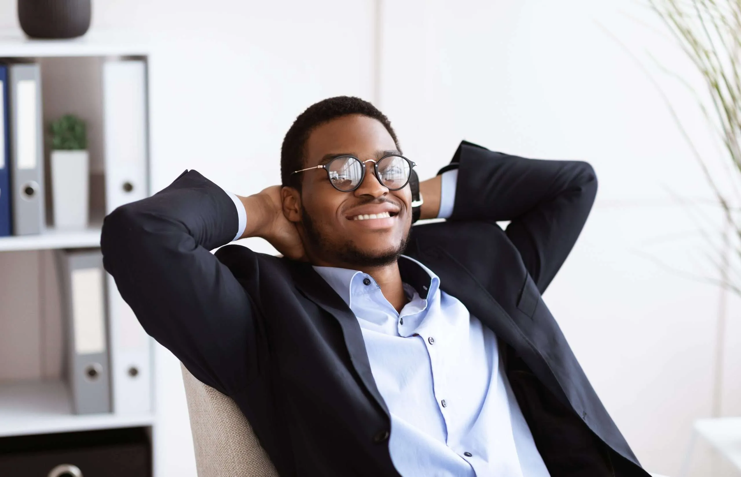 Black Business man sitting back in a chair