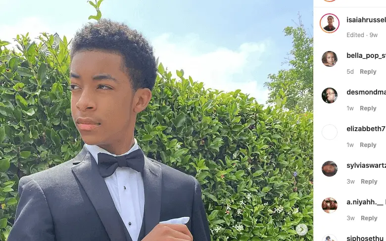 Young Black Hollywood star Isaiah Russell-Bailey posing in a suit