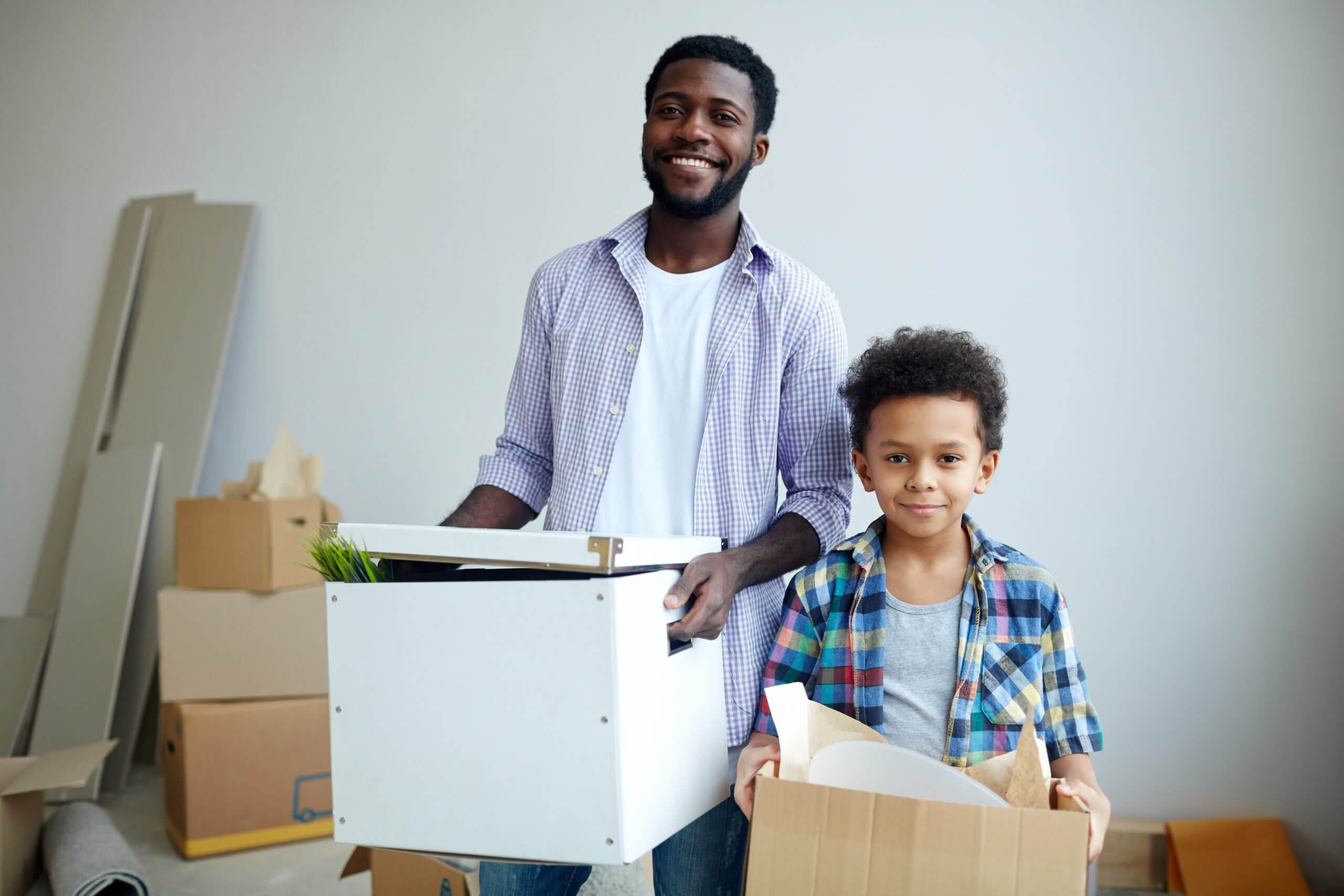 Black man and his son moving