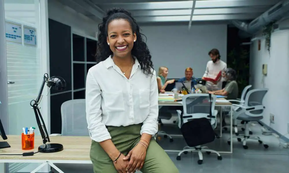 professional black woman smiling at desk