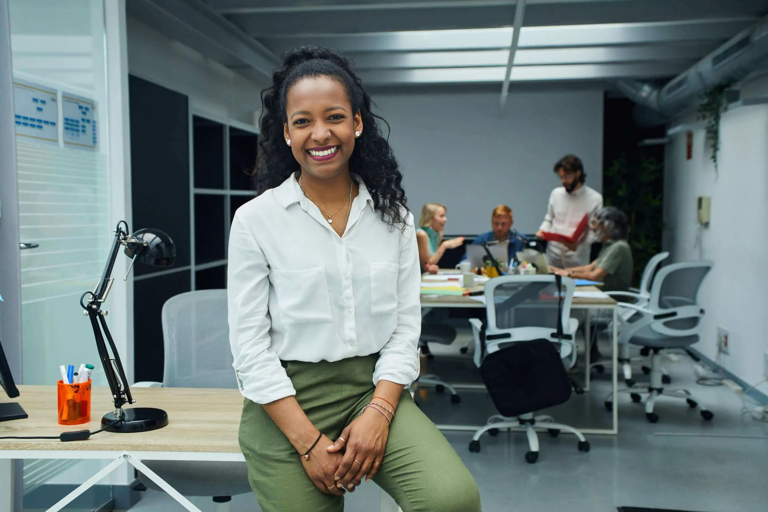 professional black woman smiling at desk