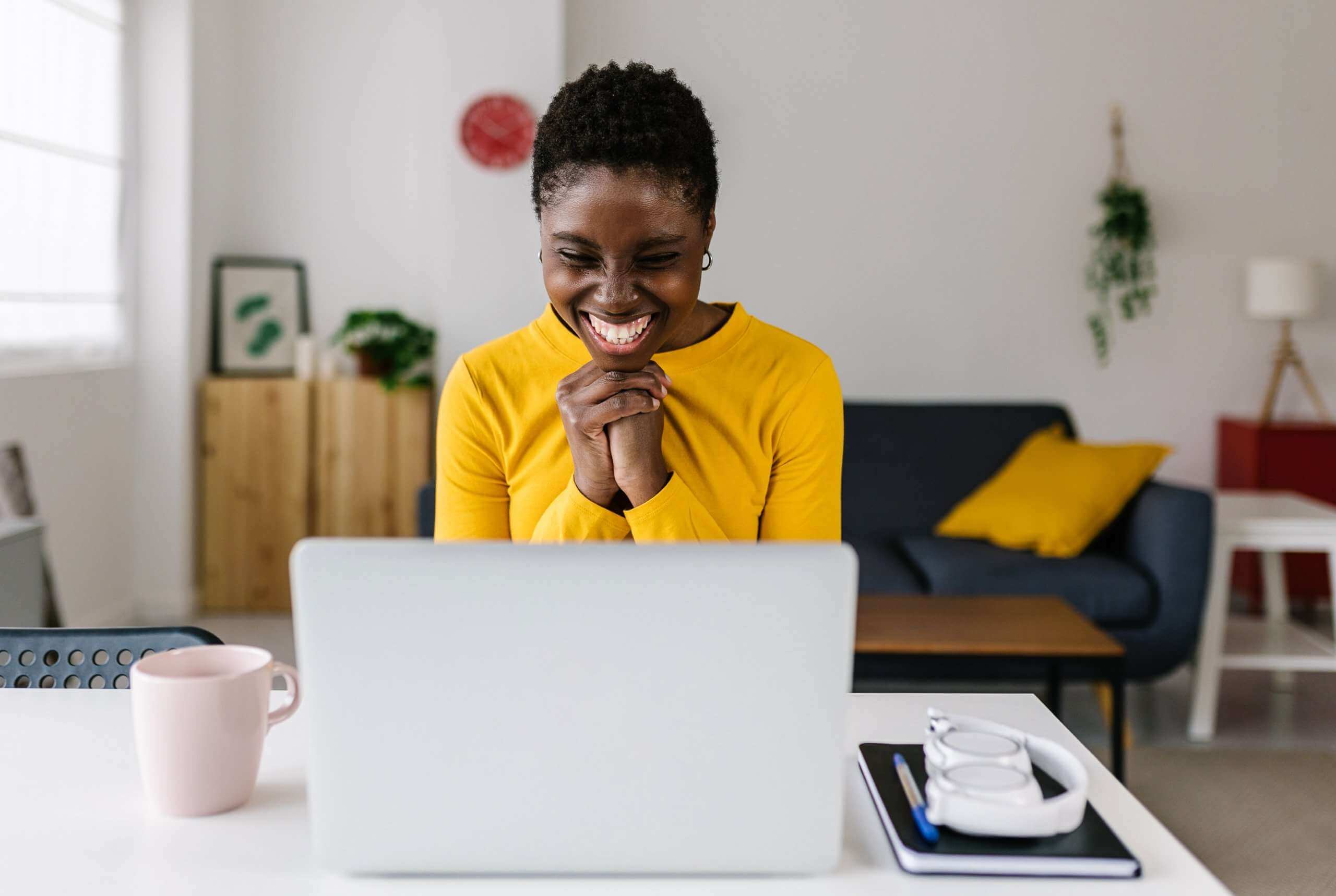 black woman looking at laptop excited